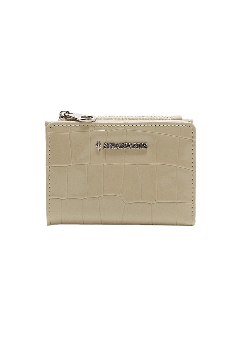 Beige leather wallet with a crocodile texture, featuring a zip closure and silver logo detailing on the front. Compact rectangular shape.