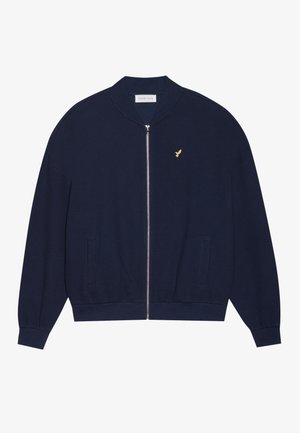 Navy zip-up sweatshirt with a textured knit, ribbed cuffs and hem, two front pockets, and a small gold logo on the chest.