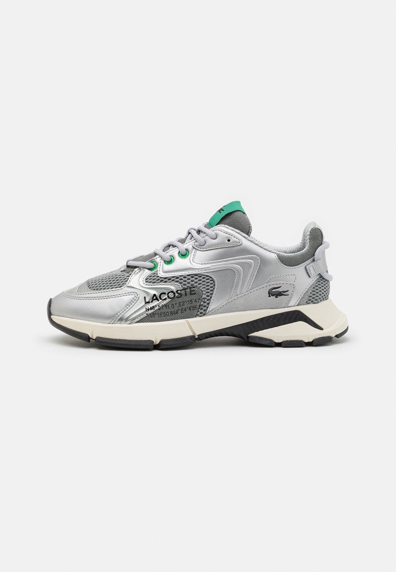 Silver athletic shoe with mesh and synthetic upper, green accents, padded collar, lace-up closure, and a thick black and white sole.