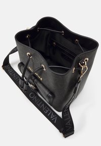 Černá kožená kabela typu bucket s texturovaným povrchem, zlatými detaily, stažením na šňůrku a popruhem s logem, který nese jméno "Valentino."