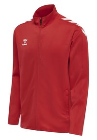 Veste de sport rouge à fermeture éclair intégrale avec logo hummel blanc sur la poitrine et bandes en chevron blanches aux épaules, avec poches latérales et col montant.