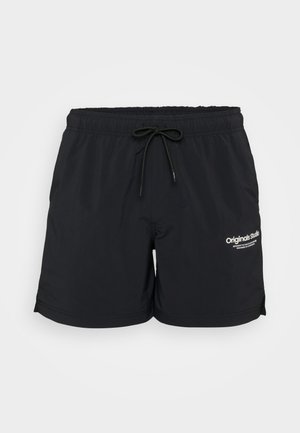 Black swim shorts with an elastic waistband and drawstring. Features side pockets and a white logo print on the left leg. Expandable hem.