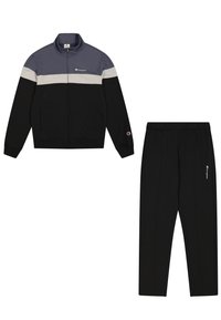 Tuta nero e grigio con giacca zip-up e pantaloni coordinati. Caratterizzato da un design a blocchi di colore, tasche e accenti del logo ricamati.
