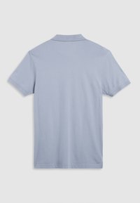Light blue short-sleeve polo shirt made of smooth cotton fabric. Features a classic collar and standard hem, with no visible patterns or accents.