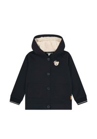 Giacca con cappuccio blu navy con un morbido rivestimento beige, dotata di due tasche frontali e un motivo di orso sul petto. Chiusura con bottoni e polsini a costine.