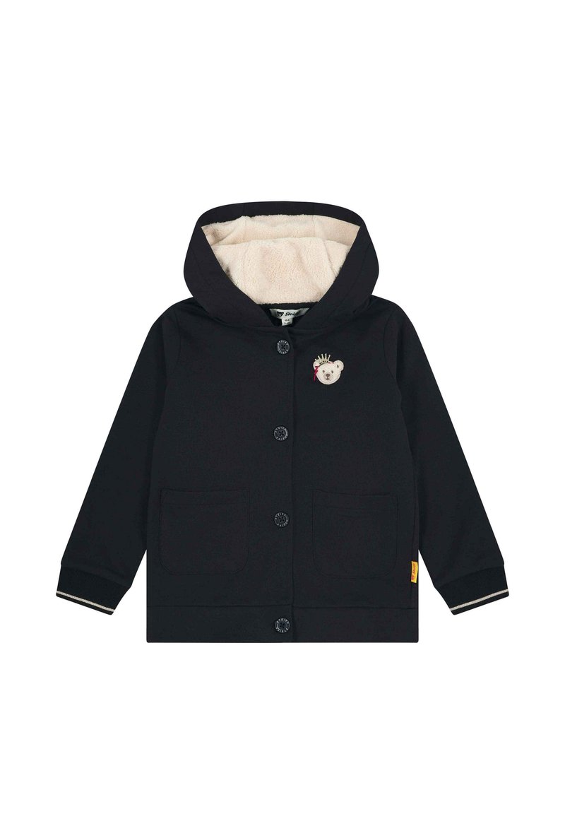 Giacca con cappuccio blu navy con un morbido rivestimento beige, dotata di due tasche frontali e un motivo di orso sul petto. Chiusura con bottoni e polsini a costine.