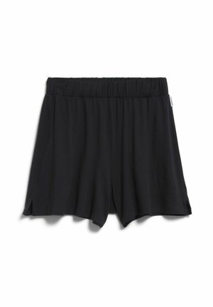 Zwarte losse shorts met elastische tailleband en kleine zijsplitten, plat liggend op een witte achtergrond.