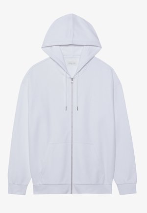 White zip-up hoodie made of soft fabric, featuring a drawstring hood, front pockets, and ribbed cuffed sleeves. Simple and clean design.