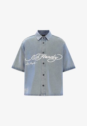 Short-sleeve denim shirt in light blue. Features buttons, a pointed collar, and white "Ed Hardy" logo with "Los Angeles" below.