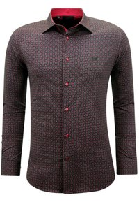 Langarmshirt in een donker patroon met rode accenten. Beschikt over een knoopsluiting aan de voorkant en een kraag, gemaakt van geweven stof.