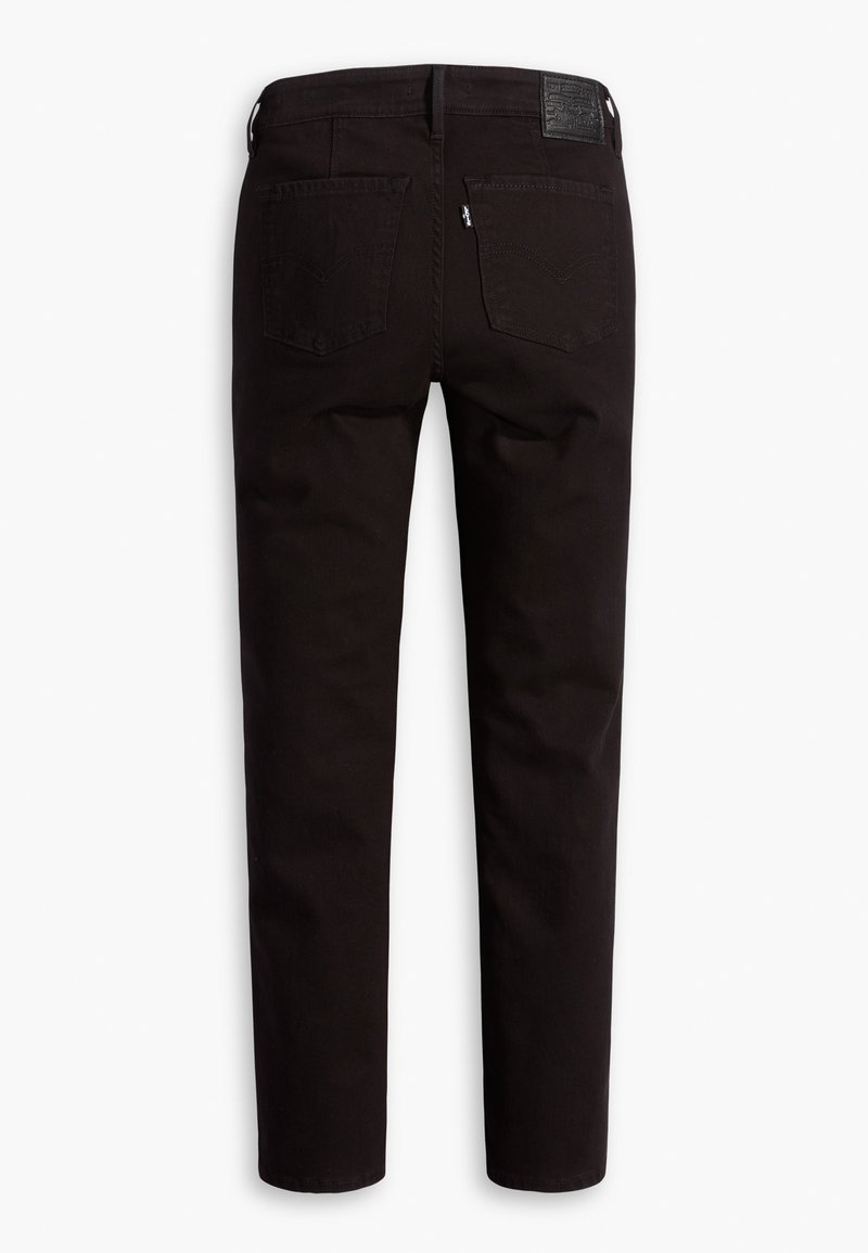 Jean slim noir vu de dos avec deux poches arrière et un patch en cuir avec logo sur la ceinture.