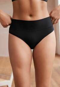 Svarta höga bikiniunderdelar gjorda av mjukt, elastiskt tyg med en slät yta och minimala sömdetaljer.