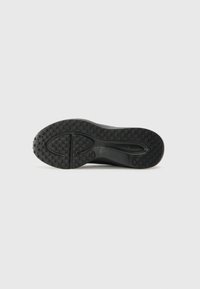 Schwarze Sneaker-Sohle mit strukturiertem Gummimuster, featuring einen glatten Rand und kreisförmigem Profil für besseren Grip. Sauberes, minimalistisches Design.