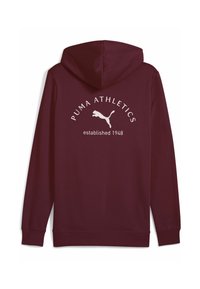 Mørkerød hættetrøje lavet af blødt materiale med et hvidt trykt logo og teksten "PUMA ATHLETICS etableret 1948" på ryggen.