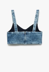 Bralette in denim con un lavaggio azzurro chiaro, dotato di spalline regolabili, design strutturato e chiusura con zip sul retro. Fodera interna morbida.