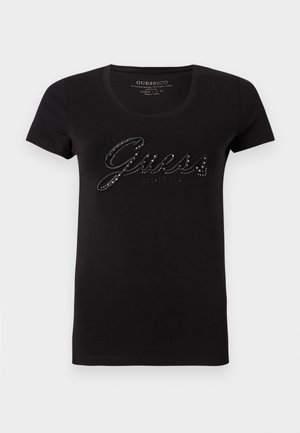 Czarny bawełniany t-shirt z krótkimi rękawami i okrągłym dekoltem. Z przodu ozdobiony błyszczącym logo "Guess" pokrytym cyrkoniami.