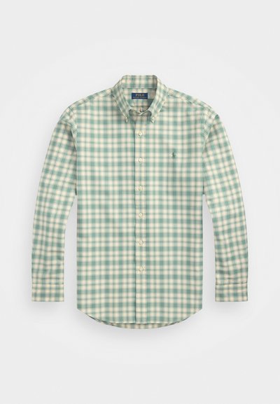 Long-sleeve button-up shirt in green and cream check pattern, made of lightweight fabric with a pointed collar and curved hem.