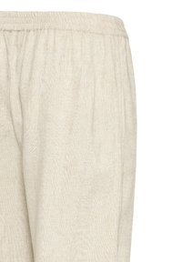 Pantalon en lin beige clair avec ceinture élastique et poches latérales, montré de la taille au haut de la cuisse.