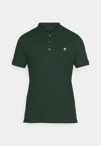 Dunkelgrünes Poloshirt aus Baumwolle, mit klassischem Kragen, Drei-Knopf-Leiste und kleinem gelben Adler-Logo auf der Brust.
