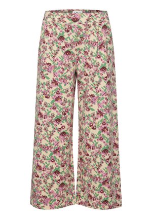 Pantalons larges fleuris en beige crémeux, ornés de fleurs roses et vertes avec une texture douce. Taille mi-haute et coupe longue.