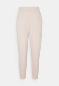 Helle rosa Sweatpants aus weichem Stoff. Mit einer schmal zulaufenden Passform, elastischem Bund und gerippten Bündchen an den Knöcheln gestaltet. Minimalistischer Stil.