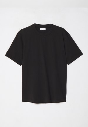 Camiseta de algodón negra con cuello redondo, mangas cortas y un corte relajado. Diseño simple, textura suave y sin patrones o logotipos visibles.