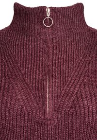 Burgundy knitted sweater with a high collar and half-zip closure. Texture features vertical ribbing and a circular zipper pull detail.