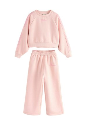 Pink cotton sweatshirt and wide-leg sweatpants set. Sweatshirt has a ribbed neckline and ‘Baker’ embroidered detail. Soft texture throughout.