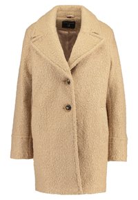 Beige textured coat with a notched collar, single-breasted design, two buttons, and side pockets. Soft, warm fabric with a slightly fuzzy surface.
