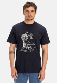 Navy blue cotton t-shirt featuring a white graphic design of a palm tree, parachute, and beach scene. Round neck and short sleeves.