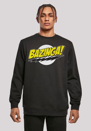 Black sweatshirt featuring a large "BAZINGA!" graphic in yellow and white, round neckline, and ribbed cuffs and hem, made from soft cotton blend.
