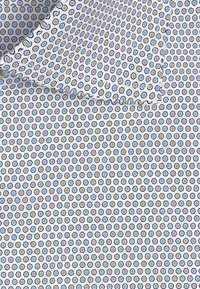 Biały materiał z powtarzającym się wzorem małych niebieskich i beżowych okręgów. Tekstura wydaje się gładka z lekko błyszczącym wykończeniem.