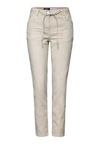 Jasnobeżowe spodnie w paski z elastycznym paskiem w talii, przednimi kieszeniami i pomarańczowymi akcentami. Slim fit z gładką teksturą.