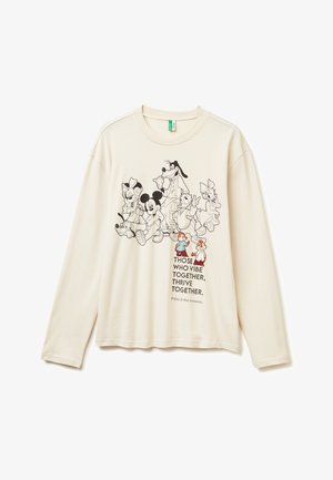 Kremowa koszula z długim rękawem z czarno-białymi postaciami Disneya oraz kolorowymi Chipem i Dale'em, nad napisem "Ci, którzy razem się vibrują, razem kwitną."