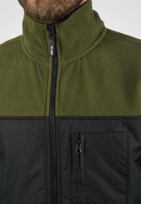 Fleece jacket with an olive green upper and black lower section. Features a high collar, front zipper, and a zippered chest pocket.