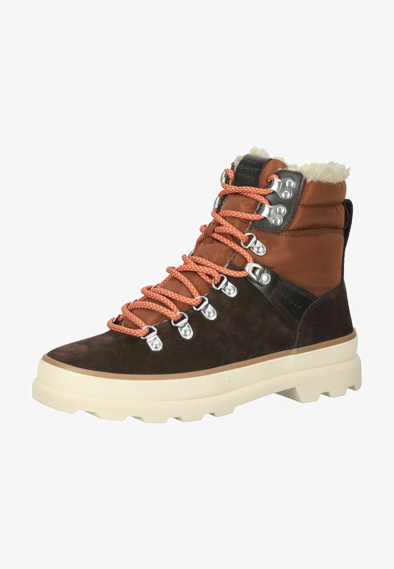 Brown suede and leather hiking boot with orange laces, silver eyelets, and a cream chunky sole. Features a fur-lined collar.