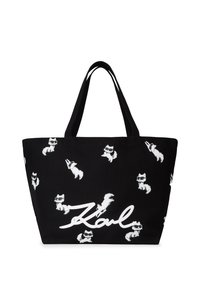 Czarna torba na ramię z białymi, rysunkowymi lisami oraz imieniem "Karl" napisanym grubym, białym pismem. Wykonana z trwałego materiału z solidnymi rączkami na ramię.