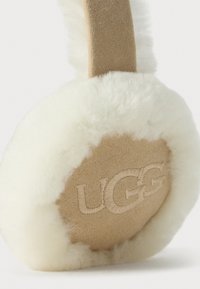 Beige suede and white fleece earmuff with UGG logo embroidered on the outer ear covering.