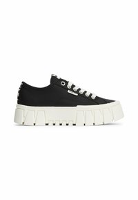 Black low-top sneaker with thick white chunky sole, white laces, metal eyelets, and small brand tag on side.