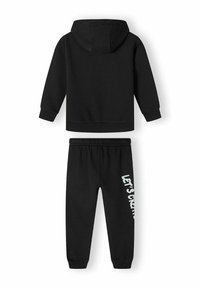 Black hoodie and sweatpants set. Hoodie has a front kangaroo pocket and adjustable hood. Sweatpants feature an elastic waistband and white text.