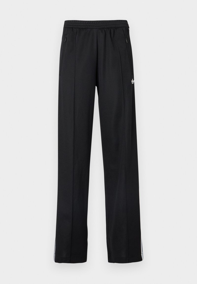 Pantalon de sport noir avec taille élastique, poches latérales zippées, bandes blanches sur le bas des jambes et petit logo blanc sur le côté.