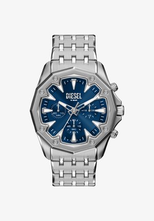 Silberne Armbanduhr aus Edelstahl mit achteckigem Gehäuse und blauem Zifferblatt. Verfügt über markante Stundenmarker, Unterzifferblätter und ein gebürstetes Metallarmband.