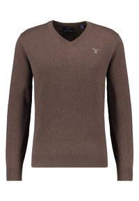 Brauner V-Ausschnitt-Pullover aus weichem, strukturiertem Stoff. Mit langen Ärmeln und einem kleinen Logo auf der Brust. Klassische Passform.