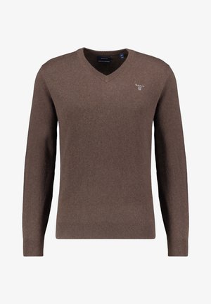 Pull V à col en V marron, fabriqué dans un tissu doux et texturé. Il présente des manches longues et un petit logo sur la poitrine. Coupe classique.