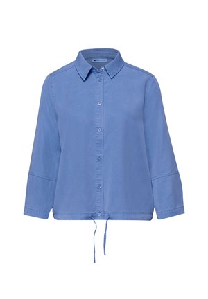 Chemise bleu clair à manches longues avec boutons, col et ourlet à cordon de serrage ajustable, présentée sur un fond blanc.
