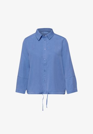 Chemise bleu clair à manches longues avec boutons, col et ourlet à cordon de serrage ajustable, présentée sur un fond blanc.