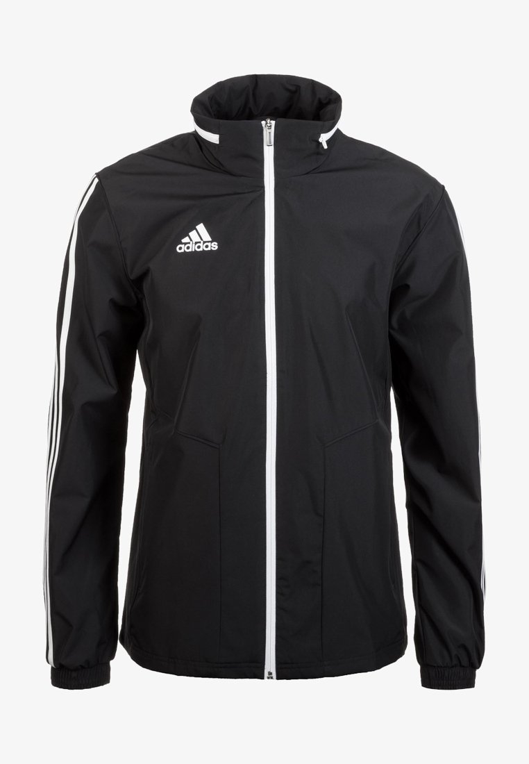 Chaqueta Adidas negra con cremallera blanca en el frente, dos bolsillos delanteros y acentos de tres rayas blancas en las mangas. Material de poliéster.