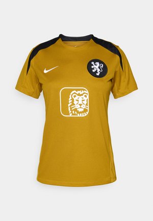 Gul sportsjakke med svarte detaljer, med rund hals, korte ermer, et løveemblem og en hvit logo i midten.