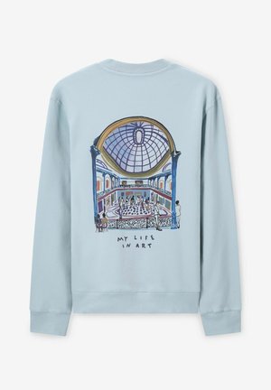 Lichtblauwe sweatshirt met een grafische illustratie van een galerie-interieur met een koepel en de tekst "MIJN LEVEN IN KUNST" onderaan.