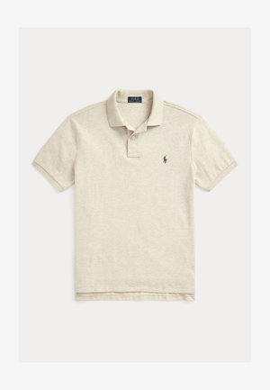 Polo beige de algodón, con una tapeta de dos botones, mangas cortas y un pequeño logo bordado marrón en el lado izquierdo del pecho.